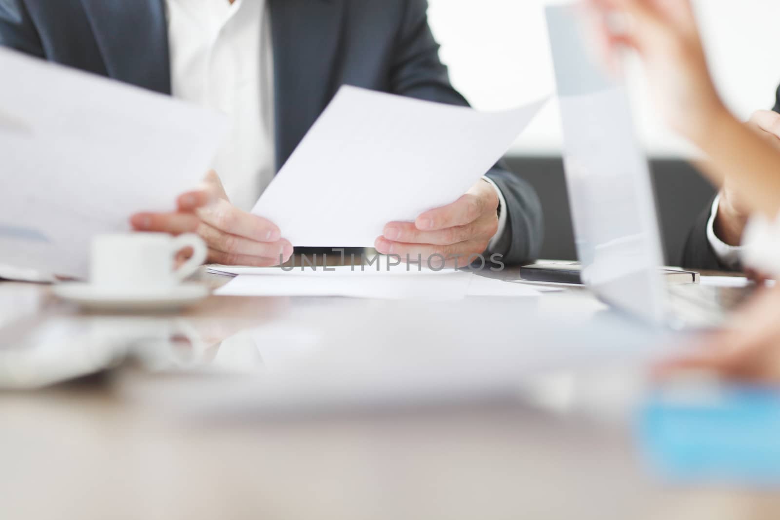 Business people working together at a meeting by ALotOfPeople