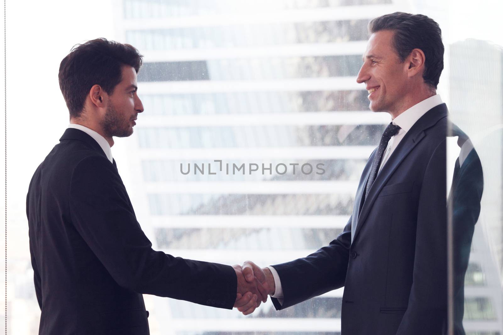 Business people shaking hands by ALotOfPeople