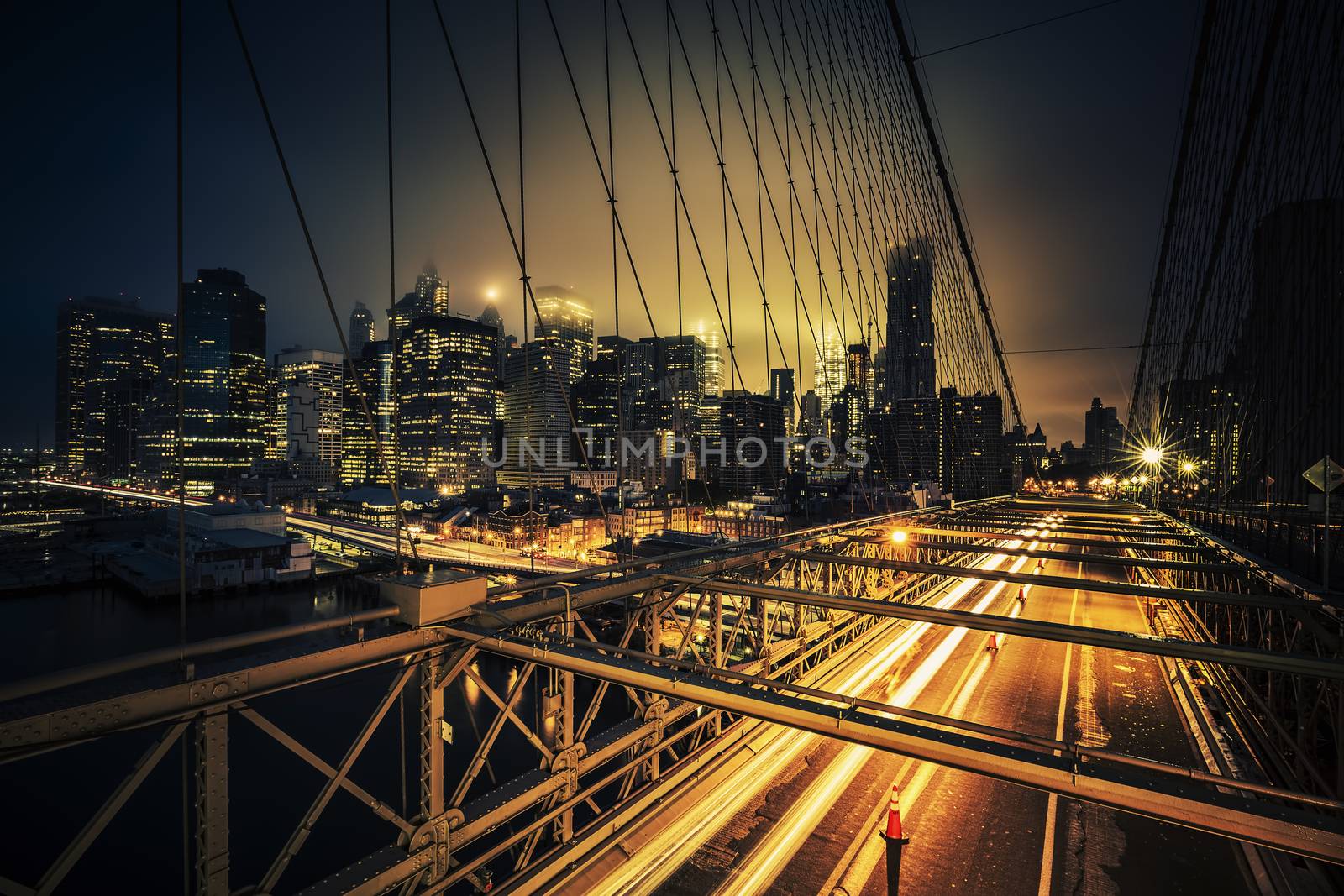 View of Brooklyn Bridge at night with car traffic