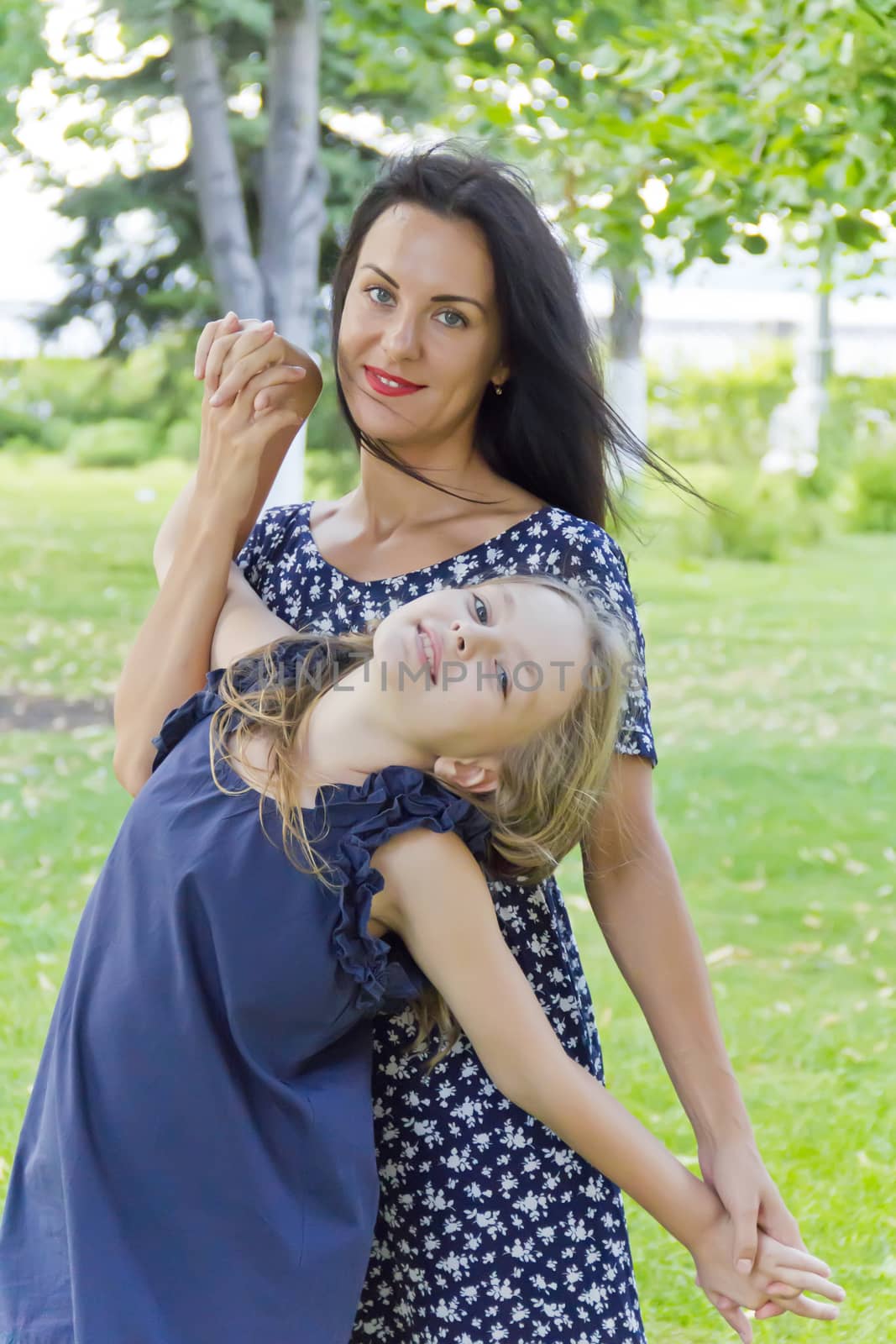 Playing mother and daughter in summer on green background