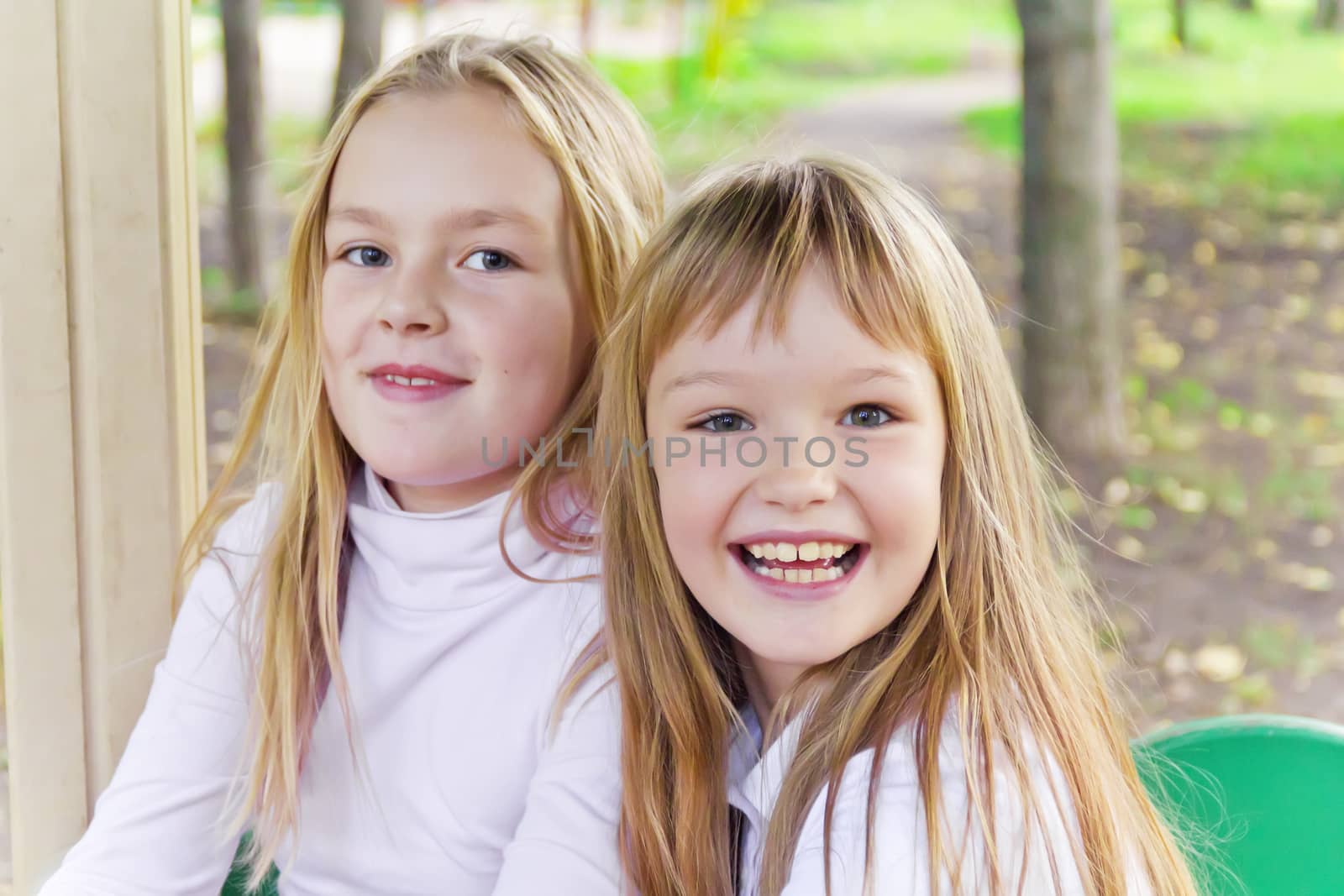 Photo of two smiling girls in summer