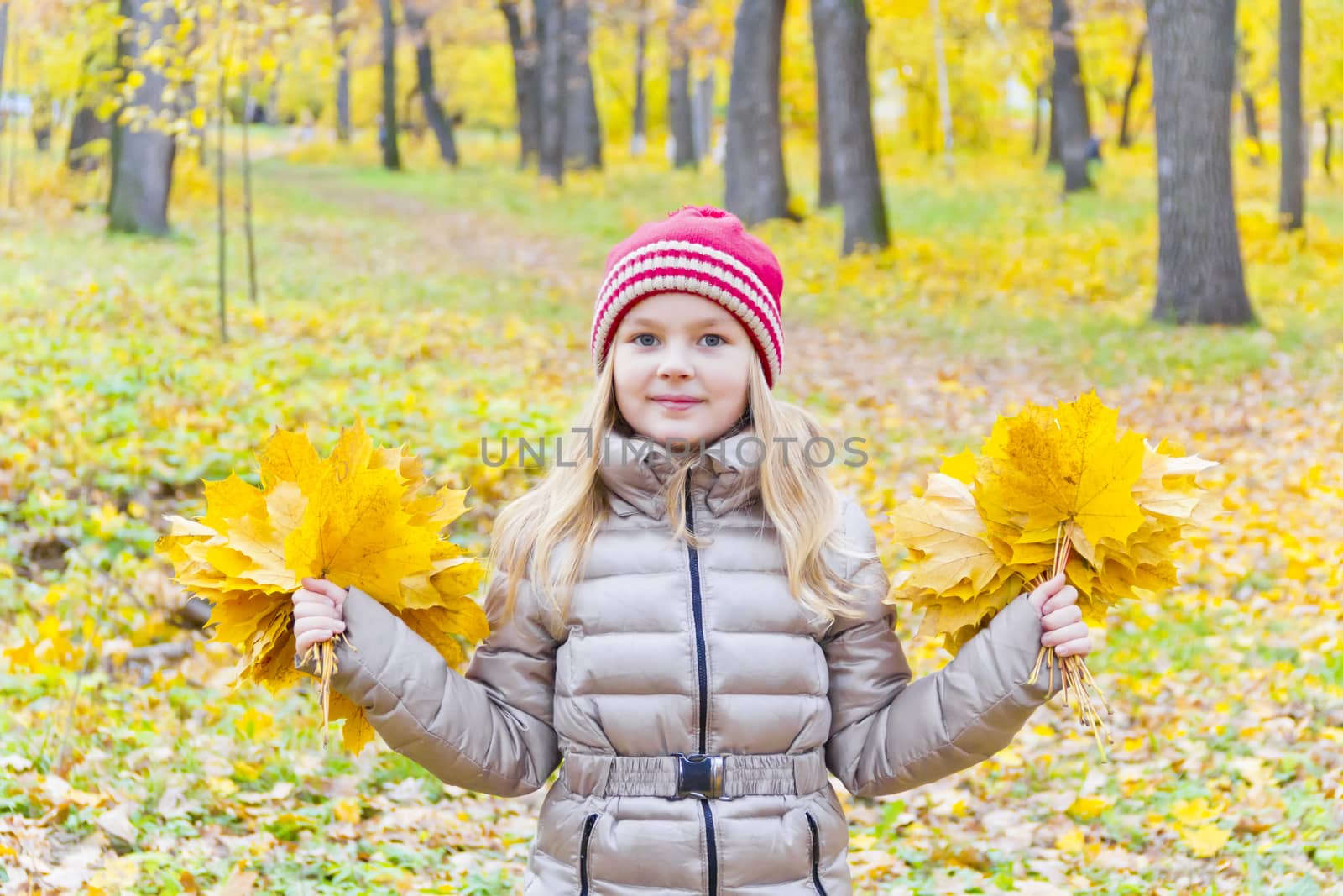 Playing girl with two bouquets from sheets in park