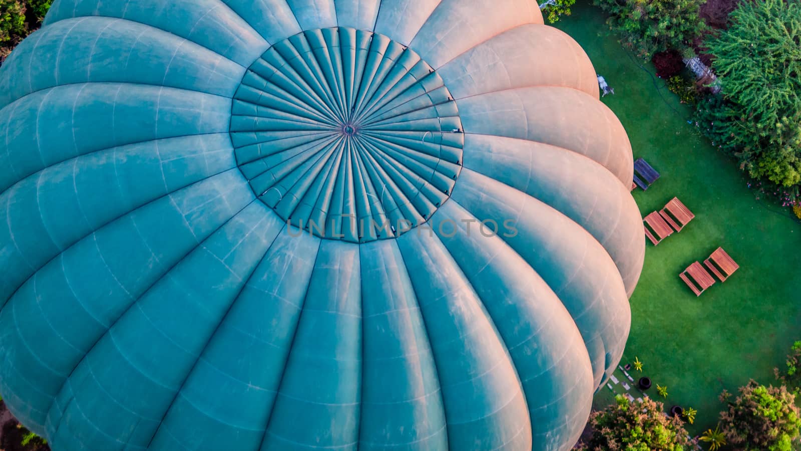 Close-up of a green hot air balloon flying over temples of and stupas Bagan in Myanmar Burma early morning