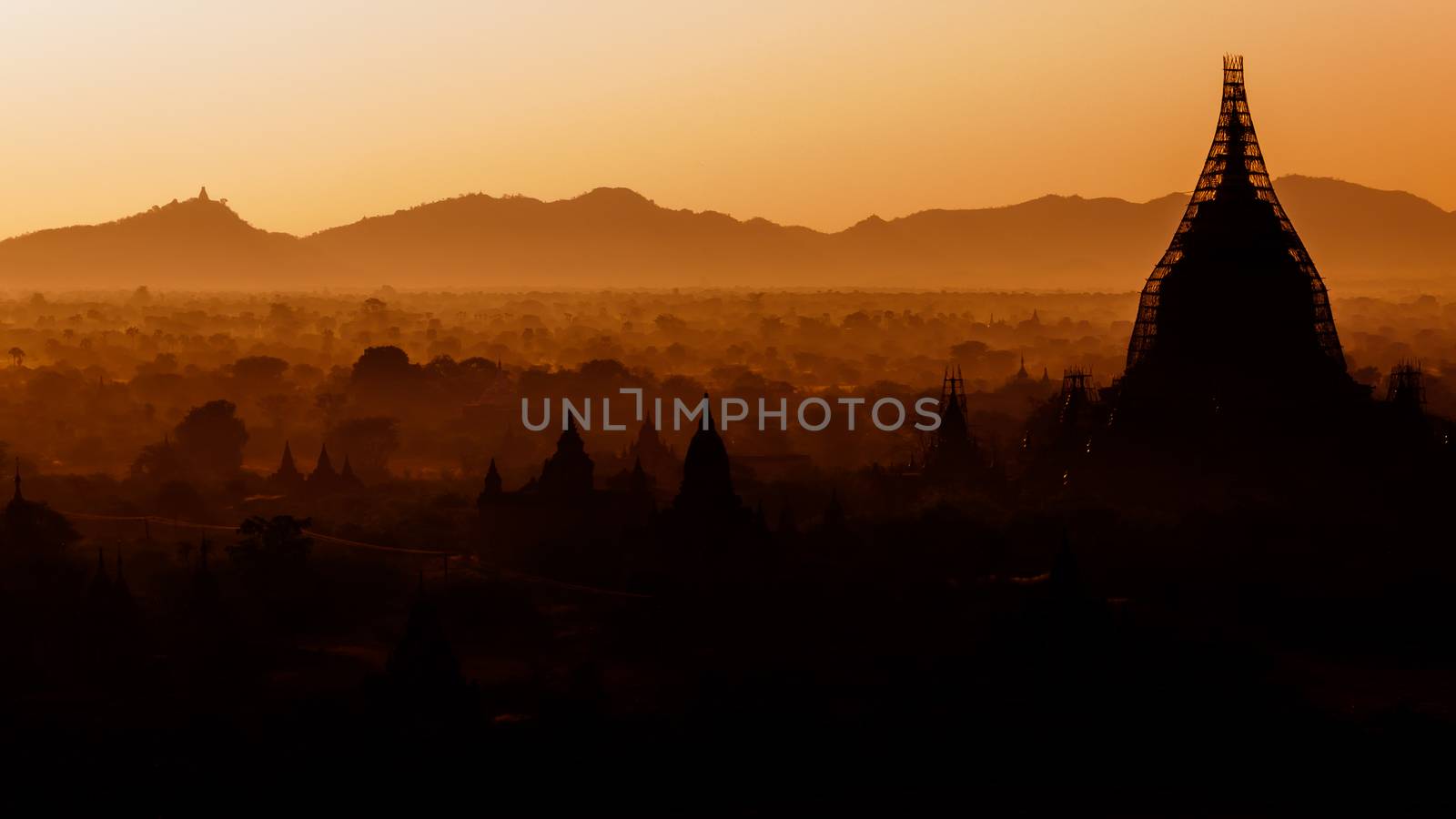 The sun is rising over the temples of Bagan