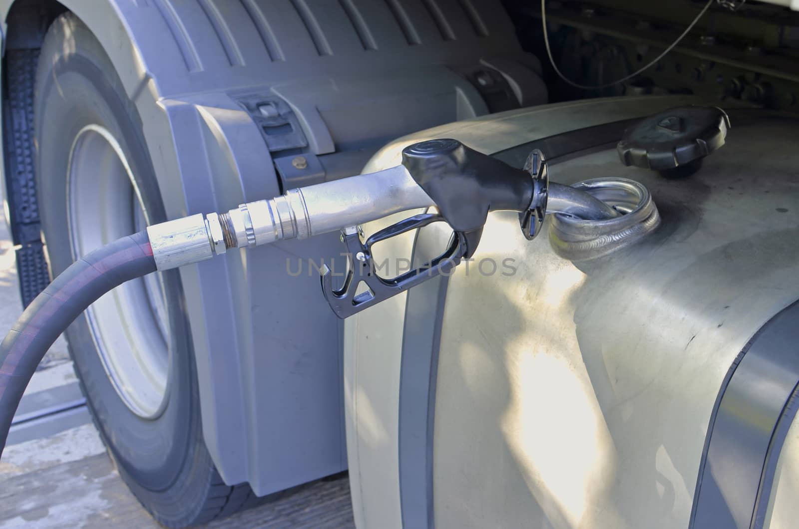 refuelling diesel to lorry tank, large hose nozzle
