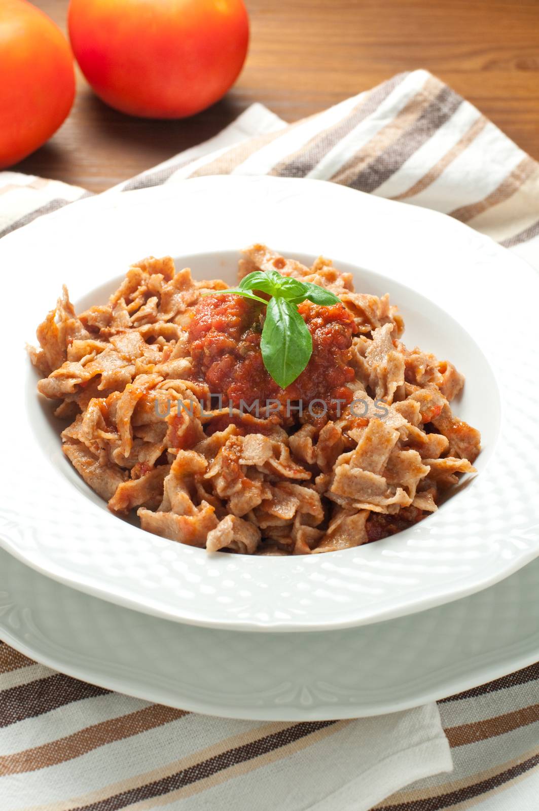 Homemade pasta topped with tomato and Parmesan integral from italy