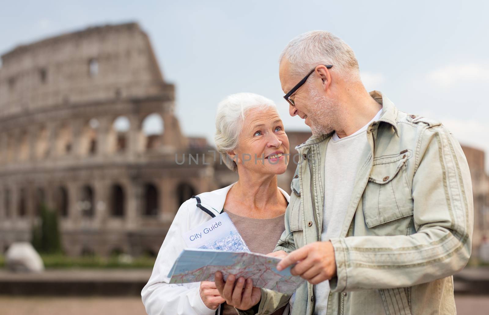 family, age, tourism, travel and people concept - senior couple with map and city guide on street over coliseum background