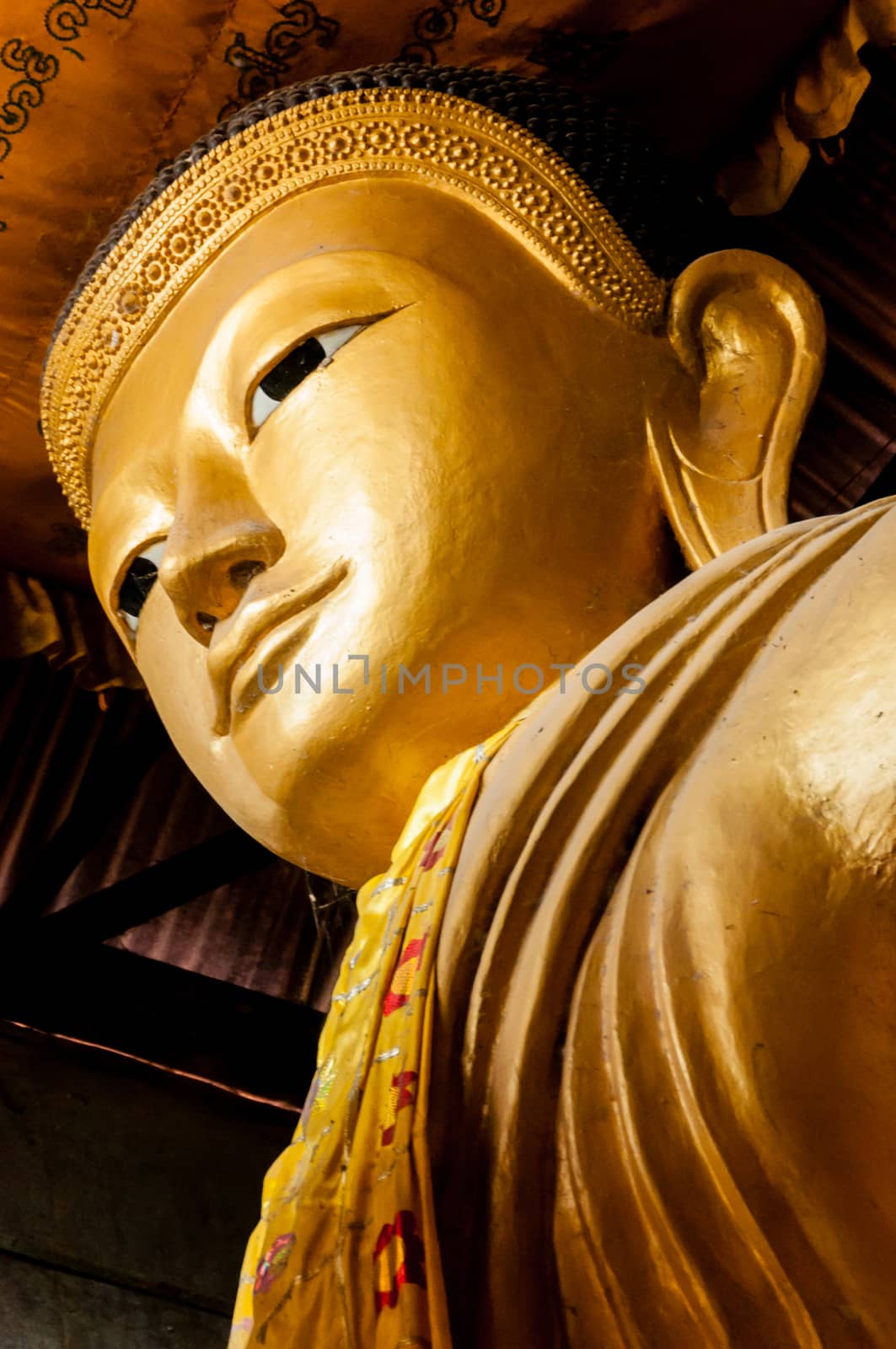 Gold Buddha Head from below in a temple in myanmar 