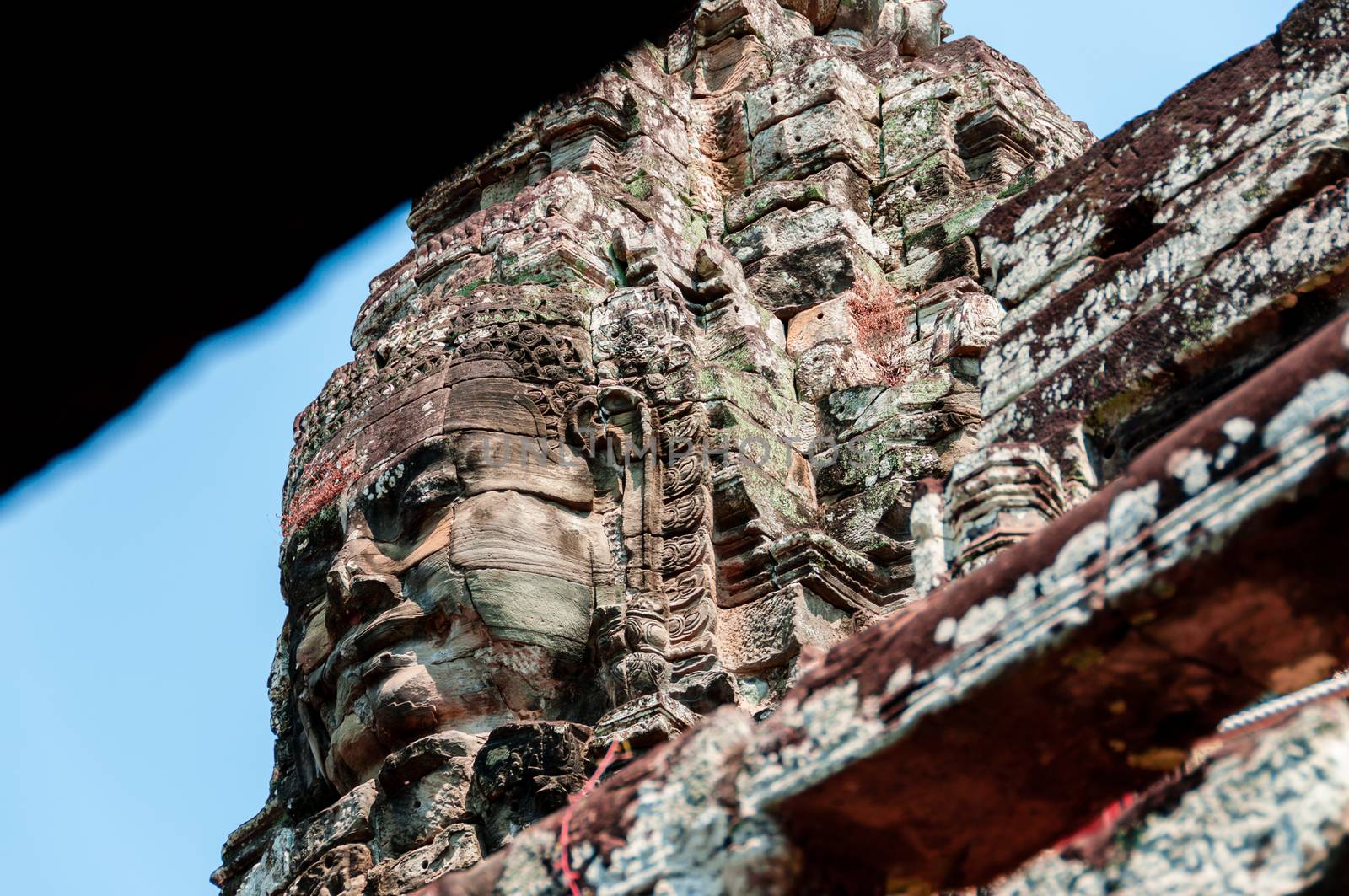 Head encarved in stone Bayon temple Angkor Wat Cambodia