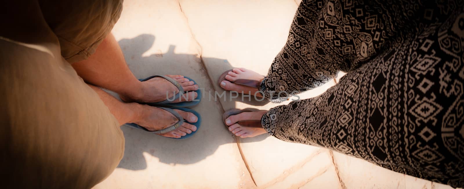 Top view of two pair dirty foot with flip flops fish-eye