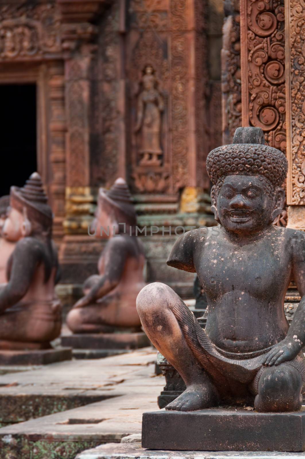 Stone sculputure sitting in front of temple Banteay Srei Angkor Wat