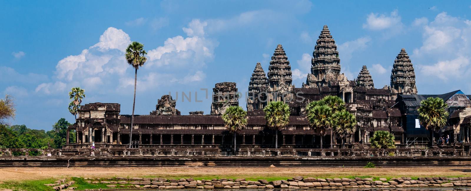 Front of Angkor Wat under cloudscape with blue sky