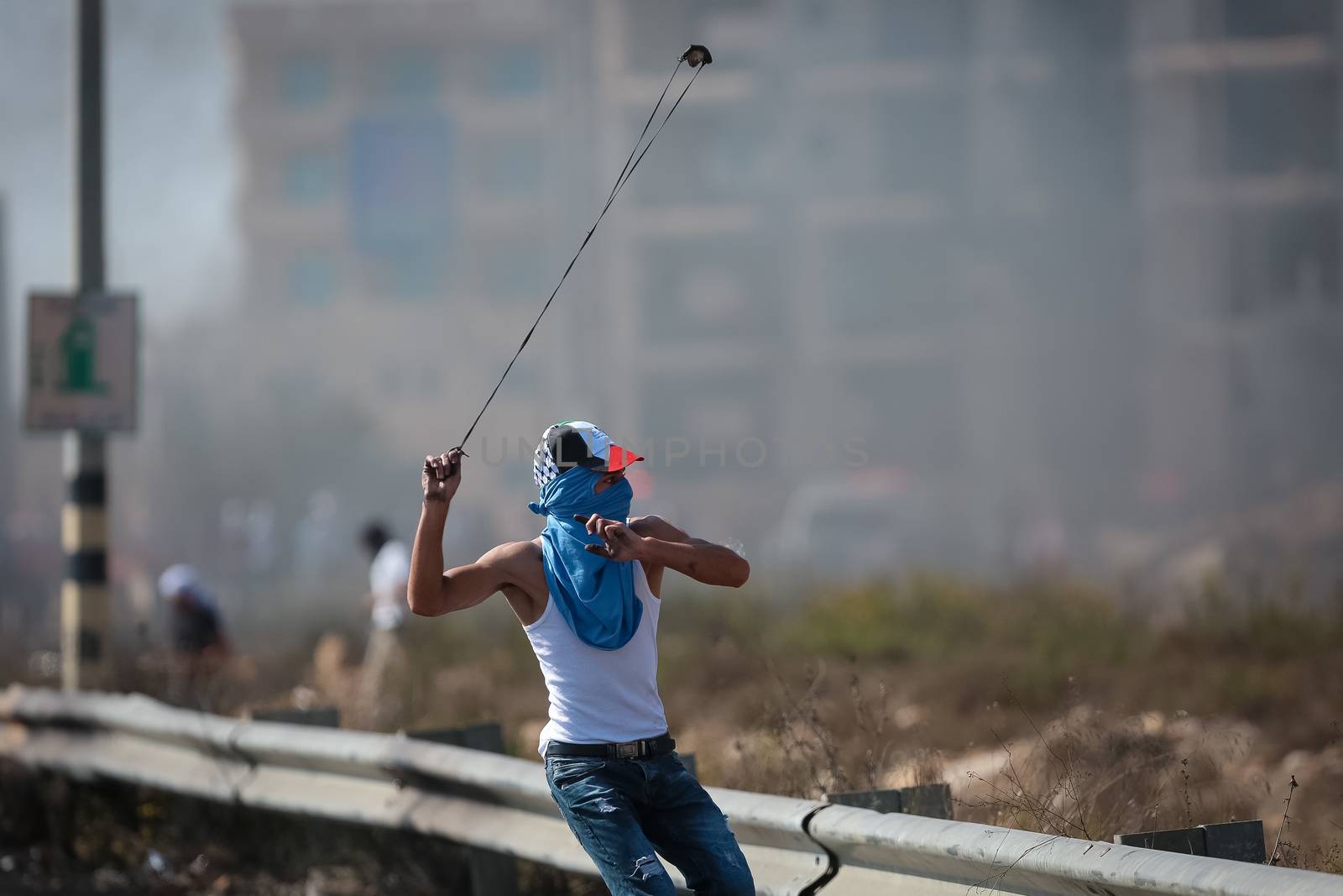 WEST BANK, Ramallah: A young masked Palestinian with a sling-shot is seen in a street of northern Ramallah, West Bank, on October 17, 2015, during clashes with Israeli army near Beit El Israeli settlement.