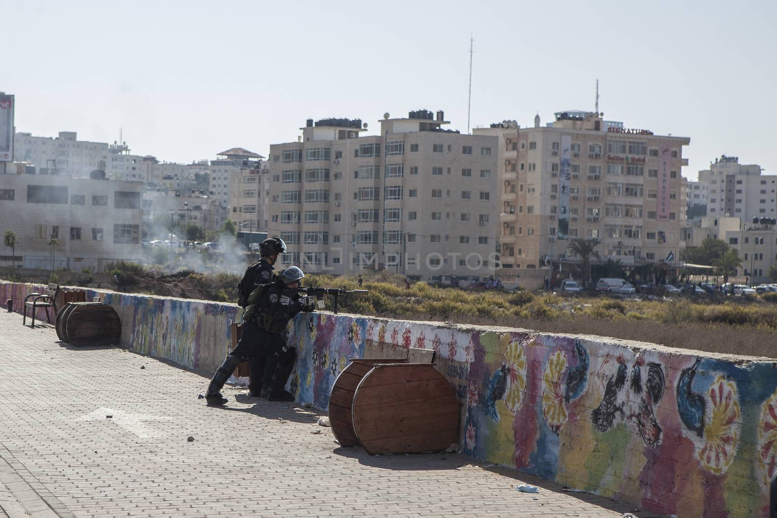 WEST BANK, Ramallah: Two Israeli soldiers shoot canisters with rubber coated steel bullets at Palestinian youth during clashes in Al Bireh, near the Israeli settlement of Beit El in the West Bank on October 16, 2015.