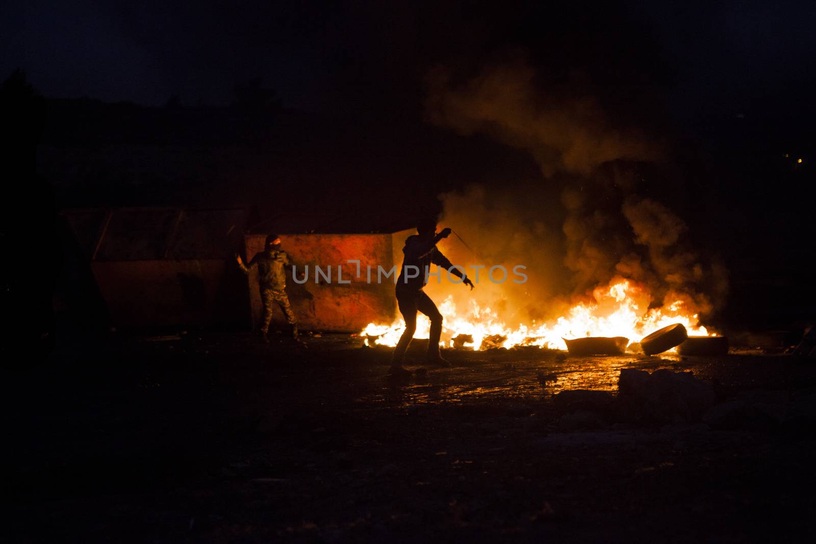 WEST BANK, Ramallah: Young Palestinian protesters throw rocks at the Israeli army in Al Bireh, near the Israeli settlement of Beit El in the West Bank on October 7, 2015.