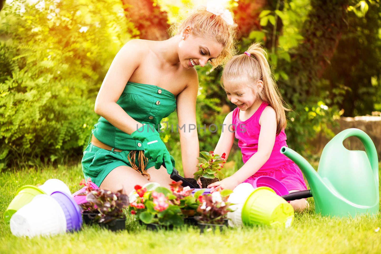 Mother and Daughter Planting Flowers Together by MilanMarkovic78