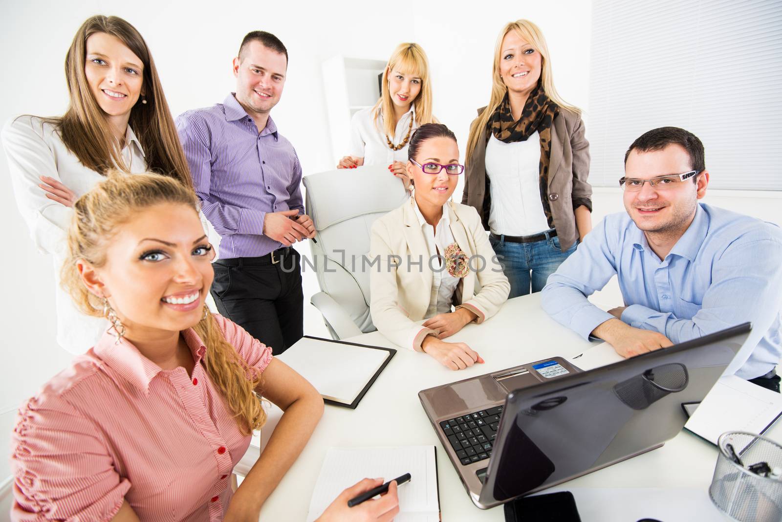 Group of a happy Successful Business People in the office looking at camera.