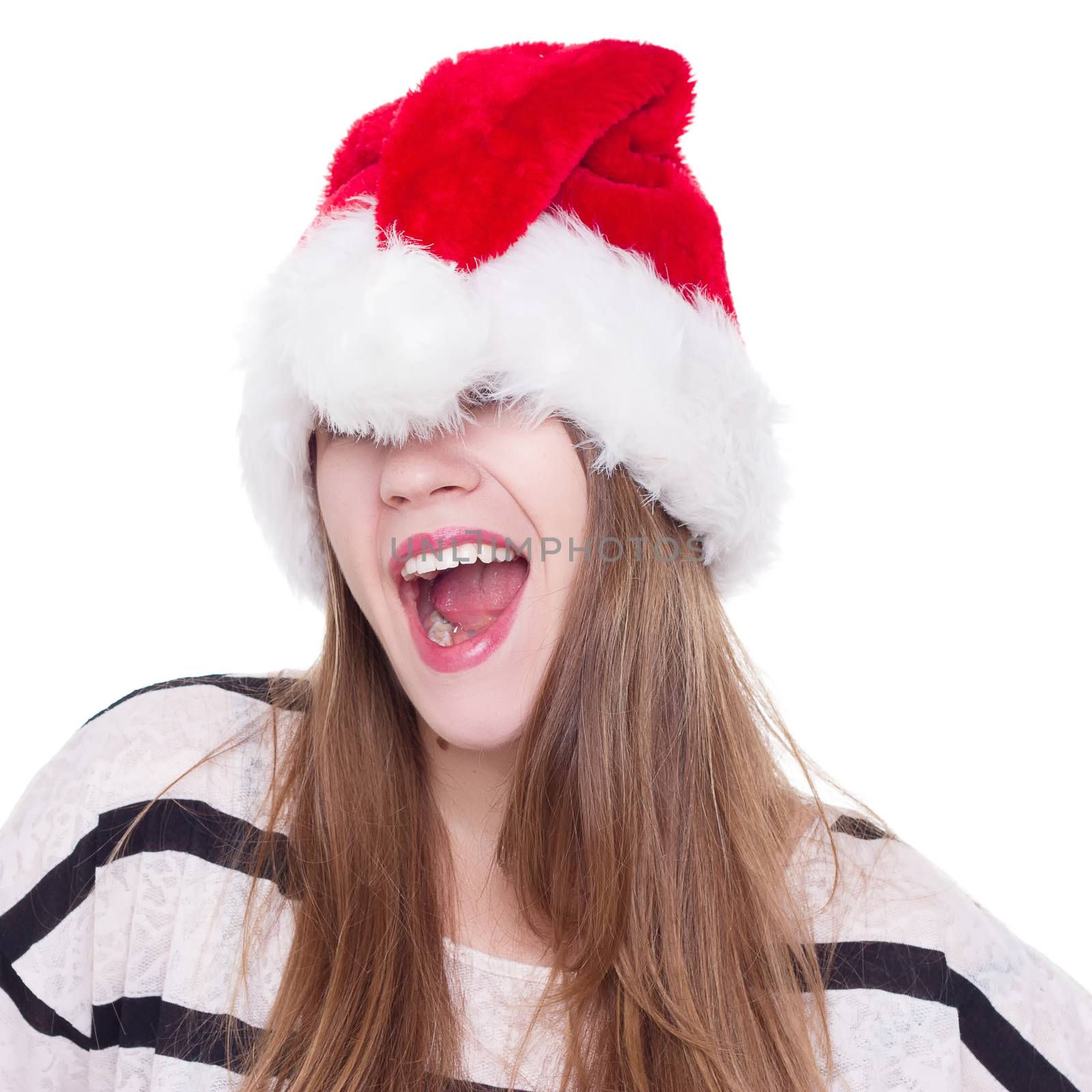 Expressive emotional girl in a Christmas hat on a white background. isolate