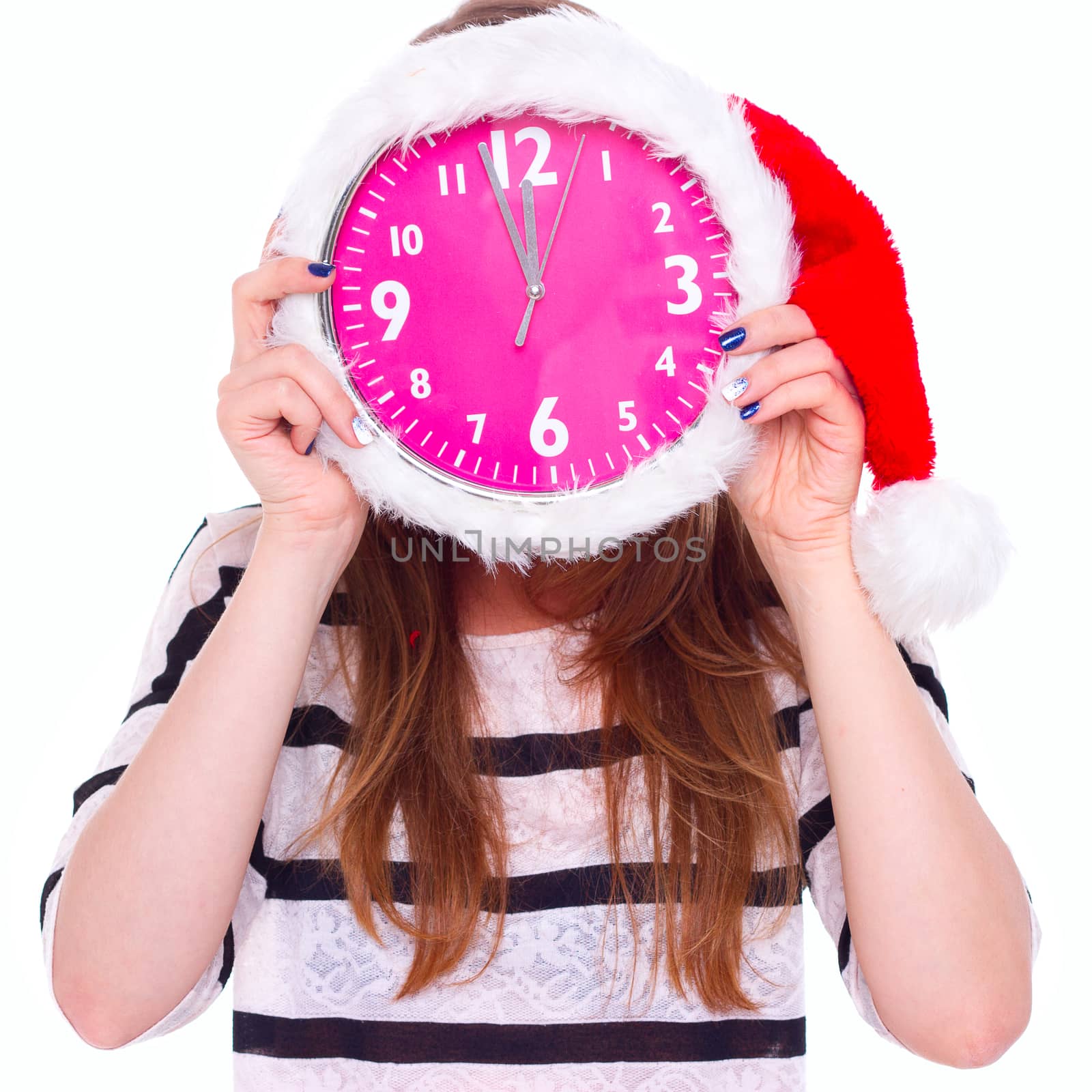 girl holding a big clock in a Christmas hat on his face. isolate