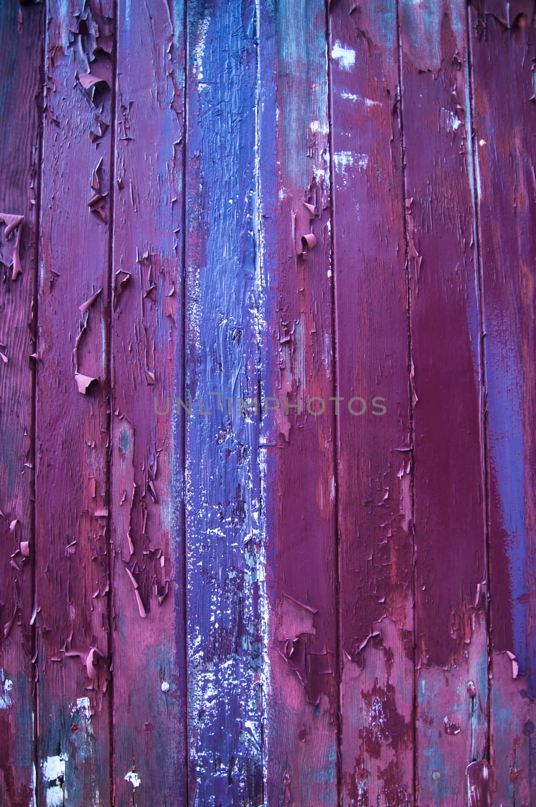 Flaking paint of purple and blue on wood by emattil