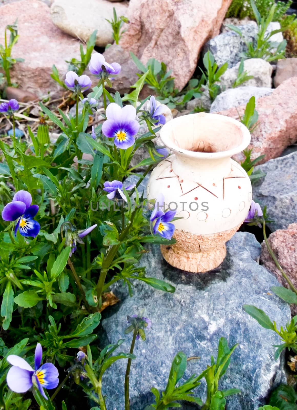 ceramic jug standing on a rock in florets