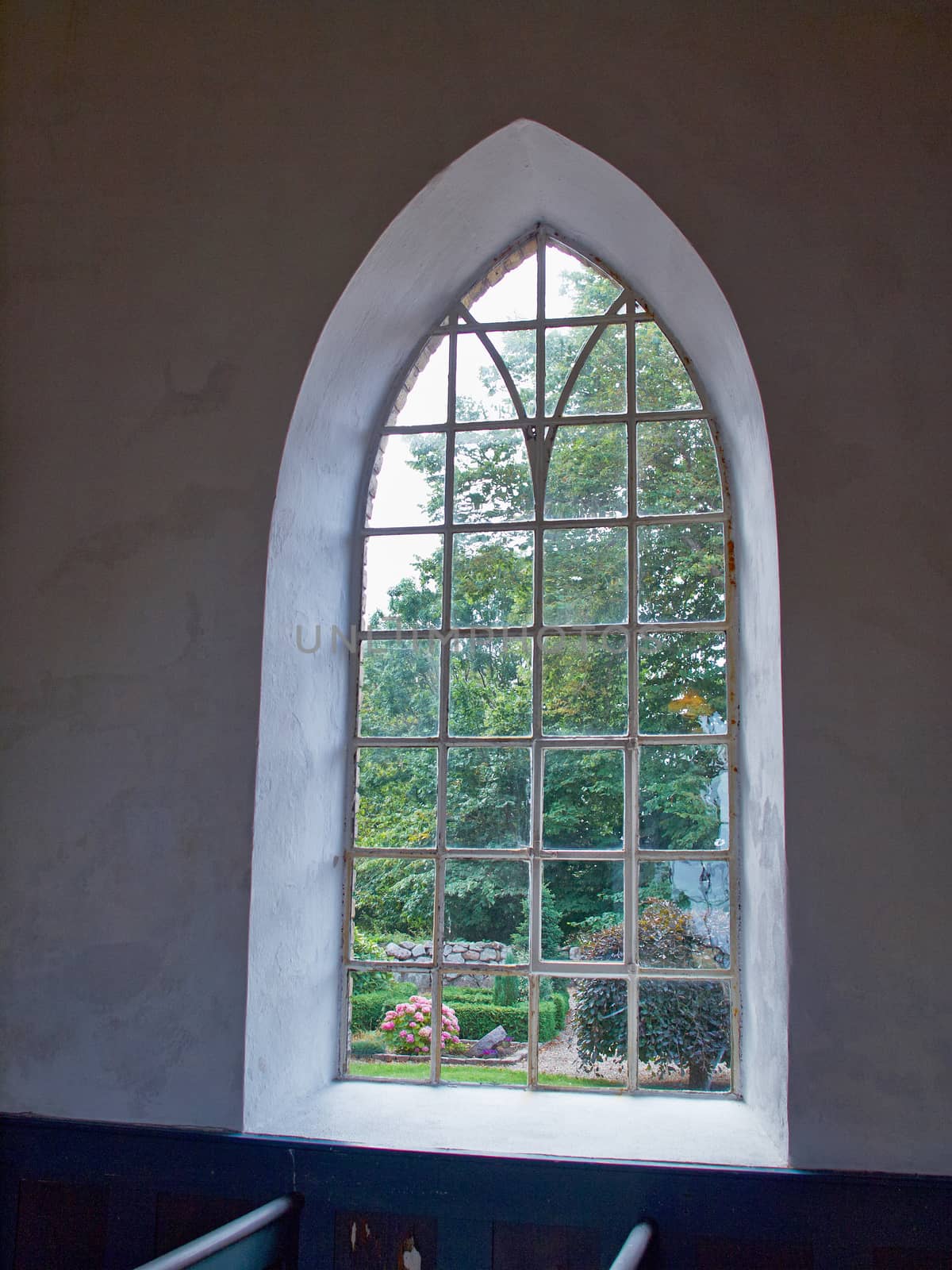 View of the world outside through a classical window of a church     