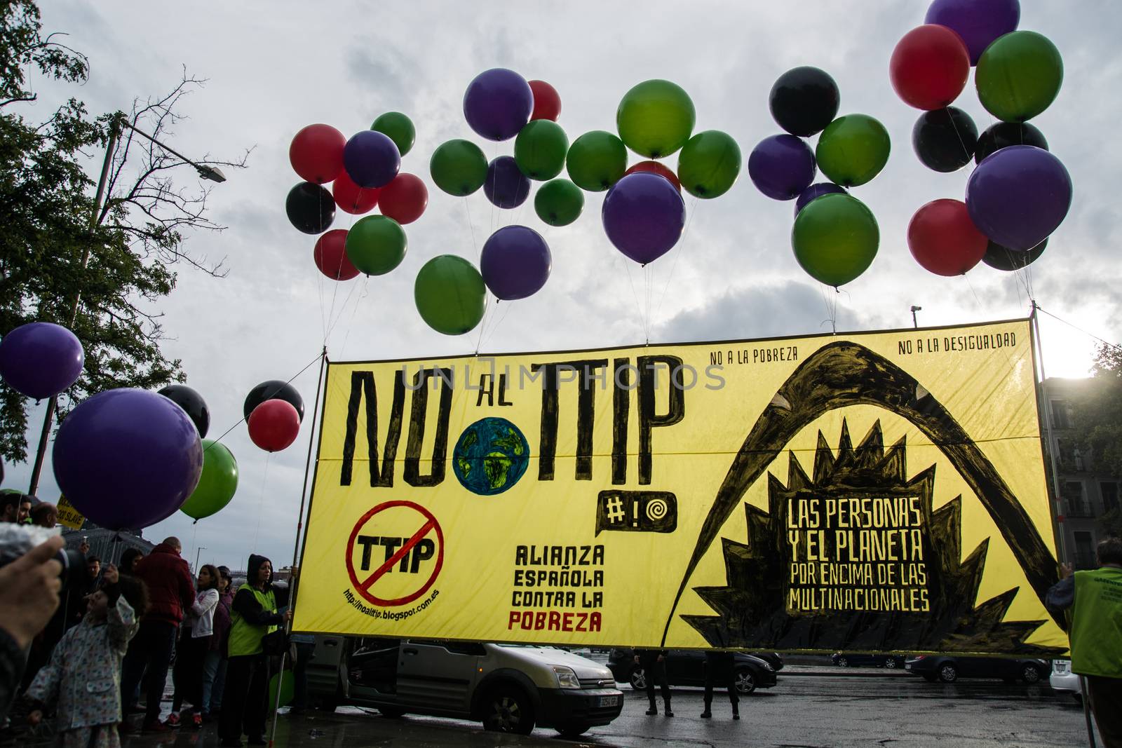 SPAIN, Madrid: Balloons and posters are displayed during a protest against the Transatlantic Trade and Investment Partnership in Madrid, Spain on October 17, 2015. Leaders are still reaching an agreement on the TTIP, a deal designed to boost the US economy and European Union by removing tariffs and other barriers to trade and foreign investment. Protesters argue the TTIP will support corporations at the expense of citizens, increase poverty and inequality and harm the environment. 