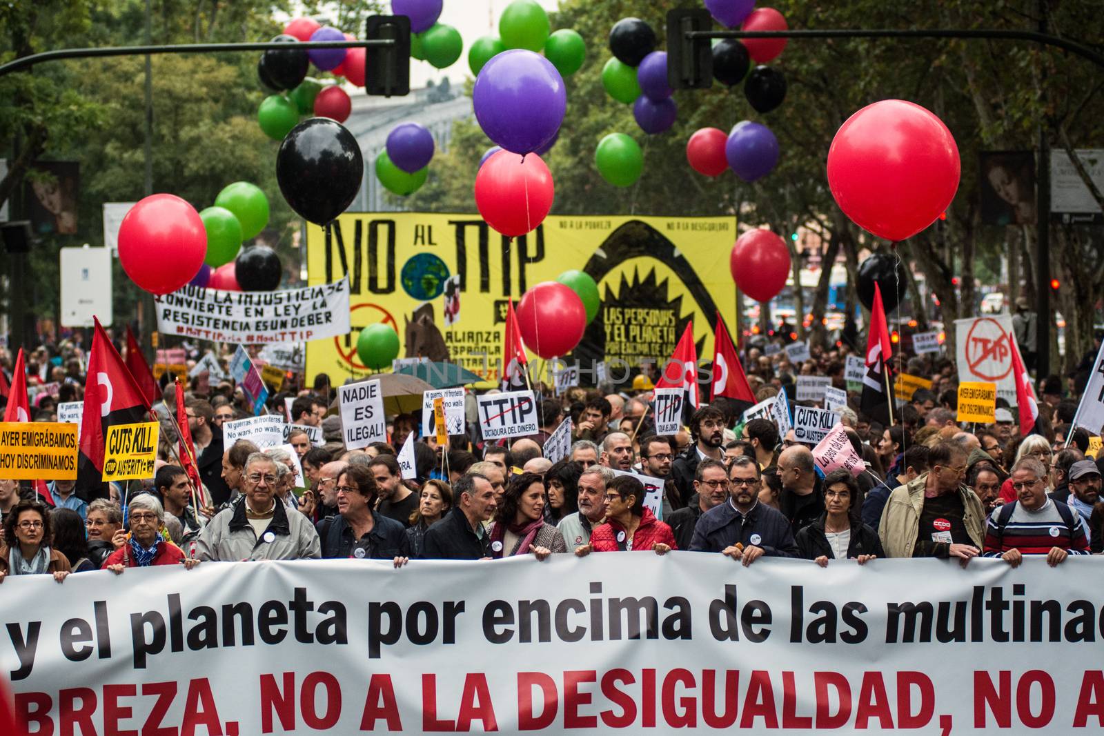 SPAIN, Madrid: Hundreds attend a protest against the Transatlantic Trade and Investment Partnership in Madrid, Spain on October 17, 2015. Leaders are still reaching an agreement on the TTIP, a deal designed to boost the US economy and European Union by removing tariffs and other barriers to trade and foreign investment. Protesters argue the TTIP will support corporations at the expense of citizens, increase poverty and inequality and harm the environment. 