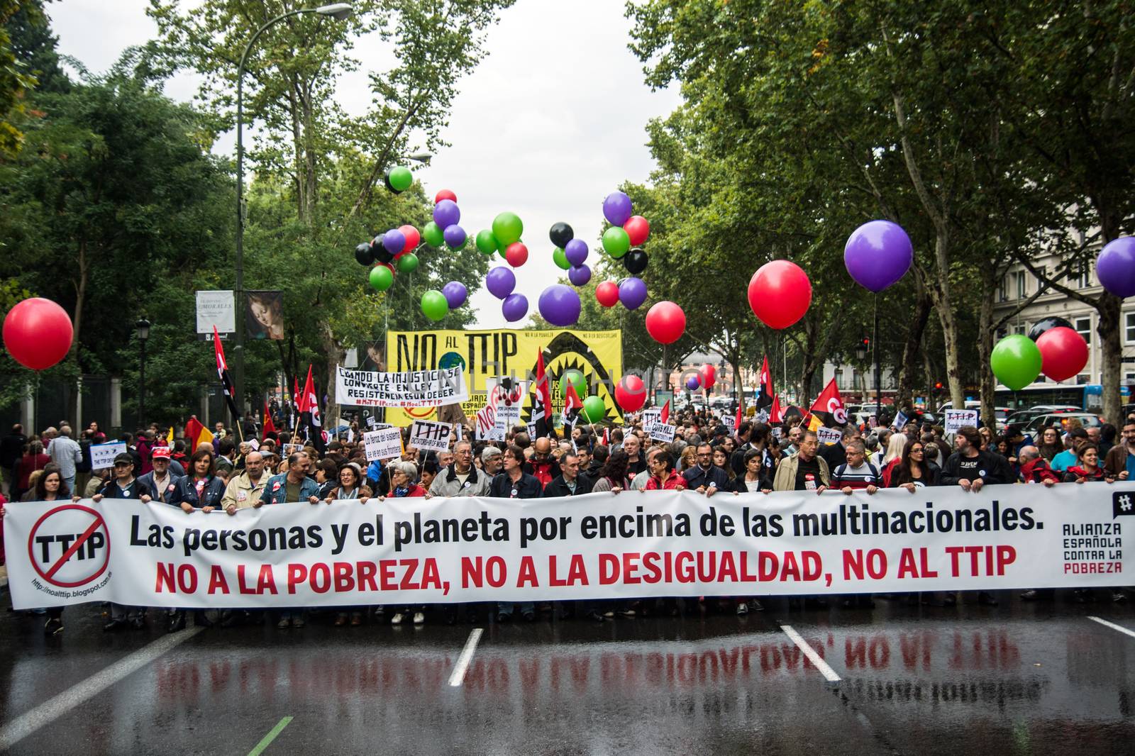 SPAIN, Madrid: Hundreds attend a protest against the Transatlantic Trade and Investment Partnership in Madrid, Spain on October 17, 2015. Leaders are still reaching an agreement on the TTIP, a deal designed to boost the US economy and European Union by removing tariffs and other barriers to trade and foreign investment. Protesters argue the TTIP will support corporations at the expense of citizens, increase poverty and inequality and harm the environment. 