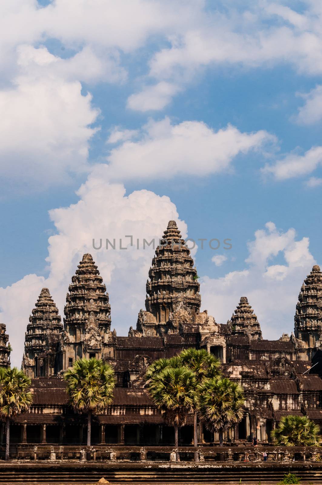 Front of Angkor Wat under cloudscape with blue sky