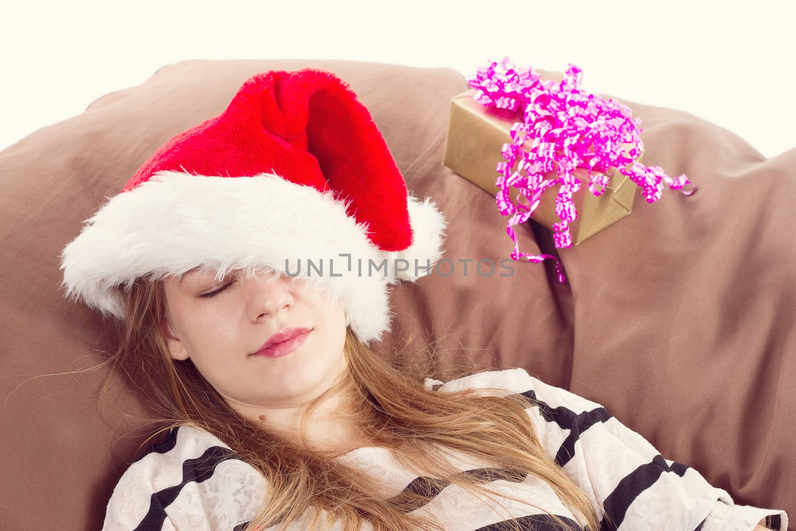 girl in a Christmas hat in the brown chair