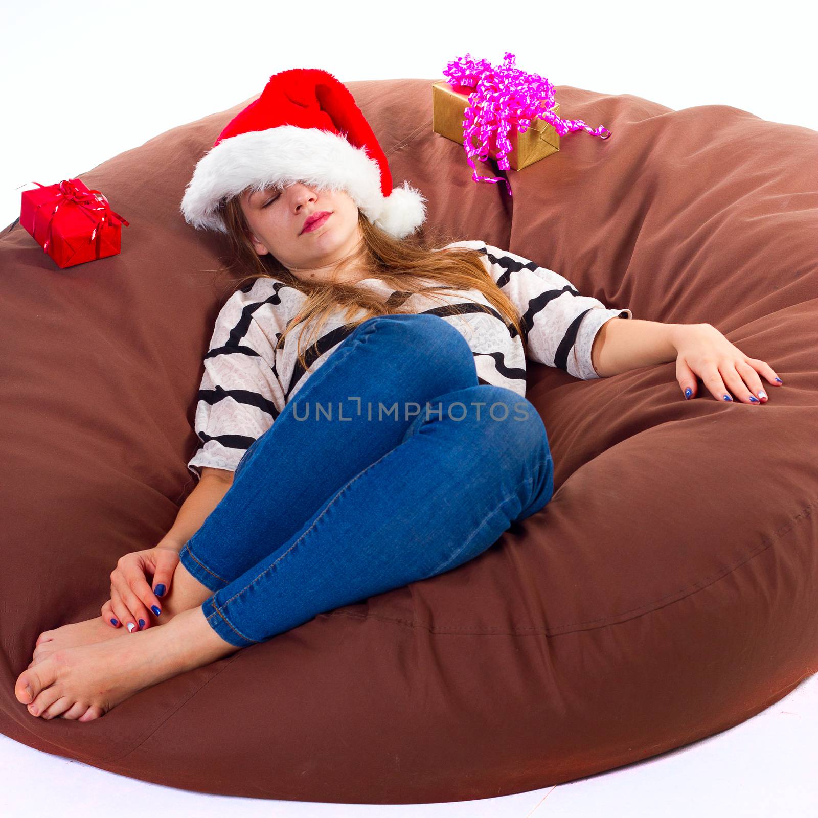 girl in a Christmas hat in the brown chair