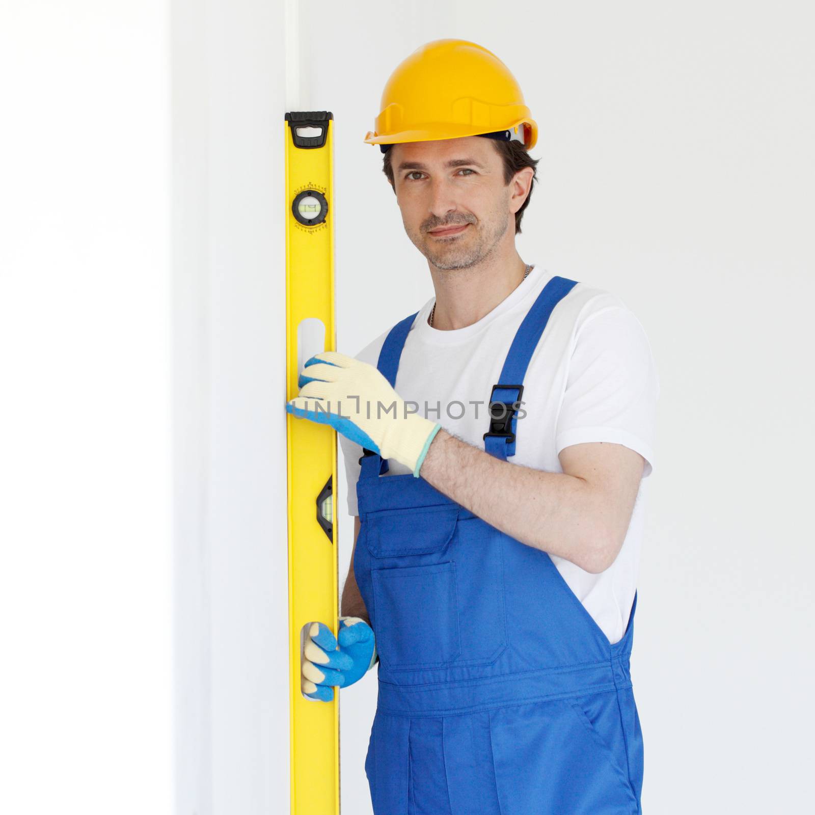 Friendly builder in helmet witha level bubble a