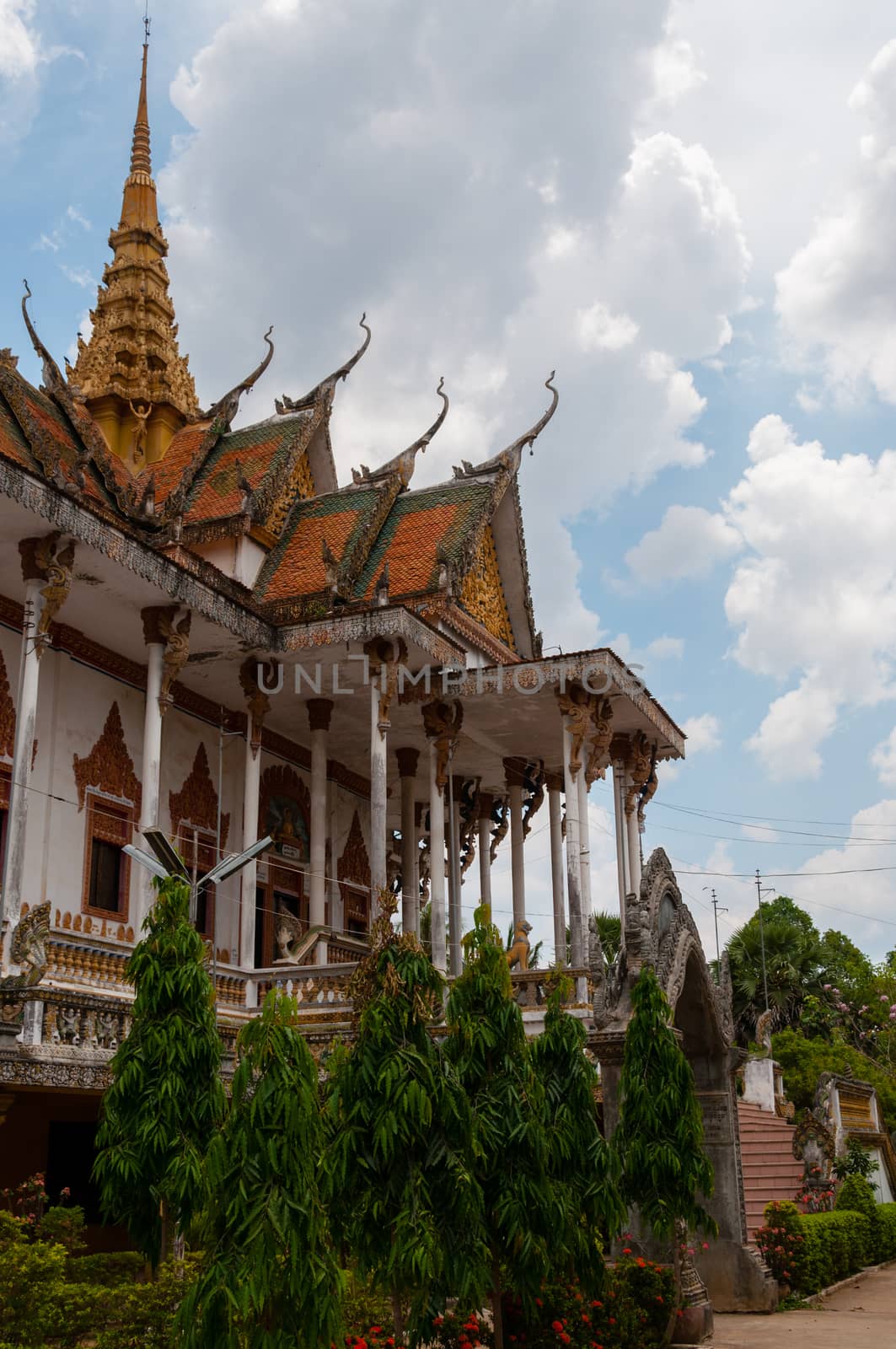 Beautiful ancient temple in Laos with a path and plants in front