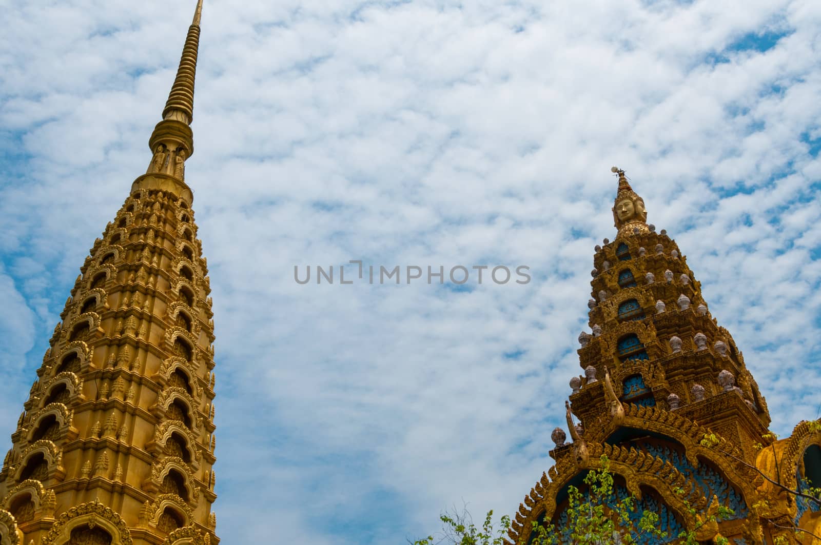 Golden Tops in front of beautiful blue and cloudy sky in Asia