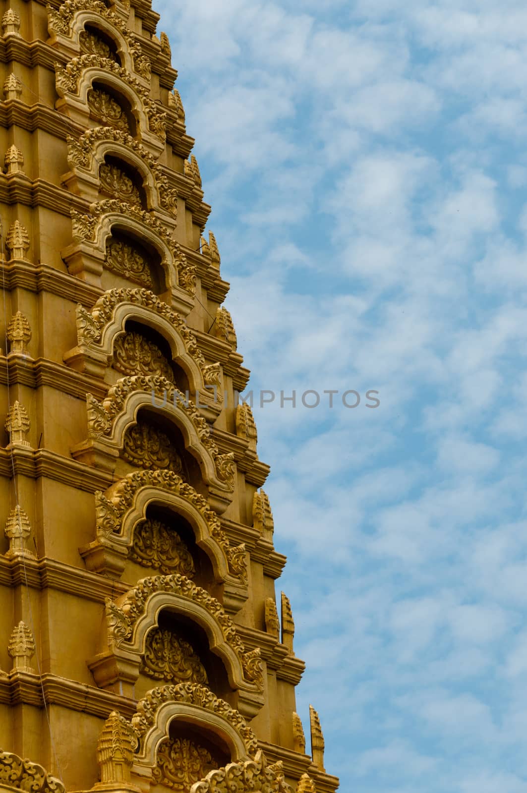 Golden temple in front of beautiful blue and cloudy sky