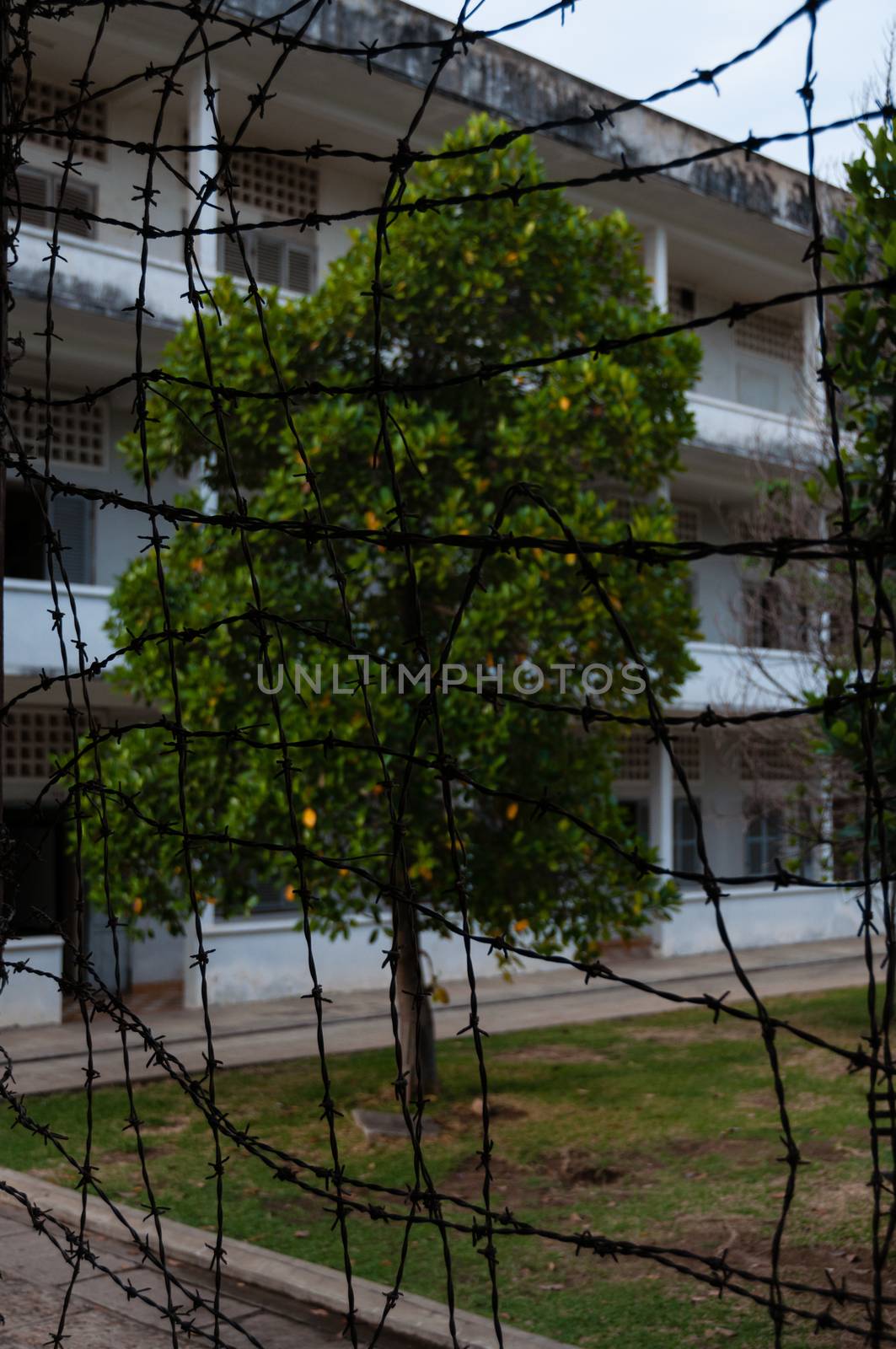 Look through Barbed wire at s21 Tuol Sleng in Phnom Penh Cambodia