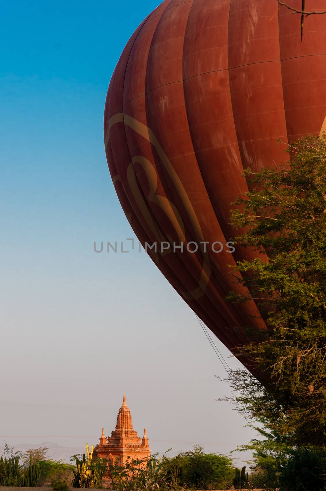Balloon in Bagan with a golden Pagoda Myanmar Burma