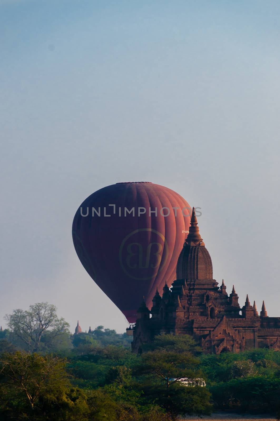 Hot air balloon behind temple in Bagan by attiarndt