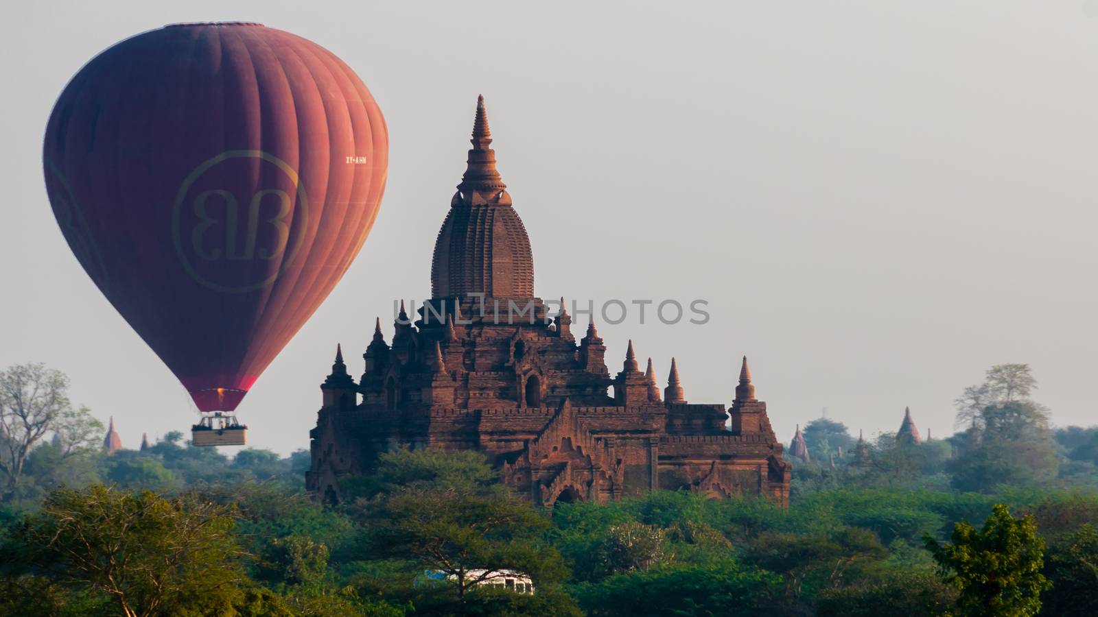 Hot air balloon behind temple in Bagan by attiarndt