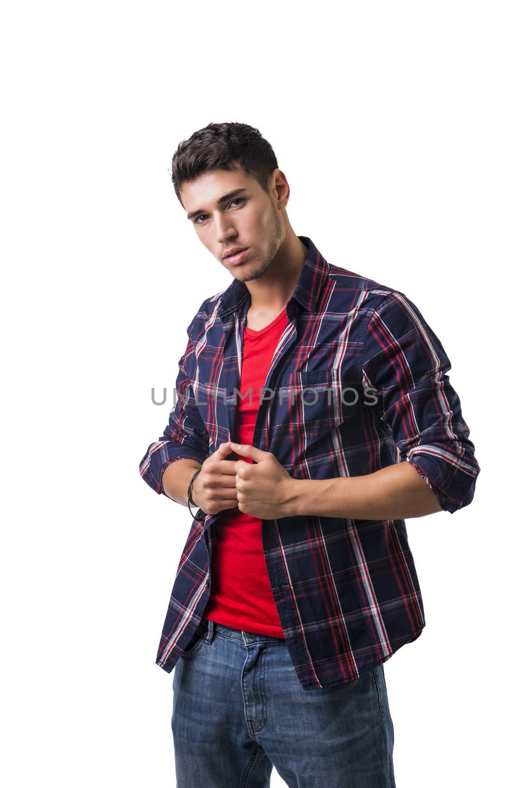 Serious young man looking at camera isolated in white background by artofphoto