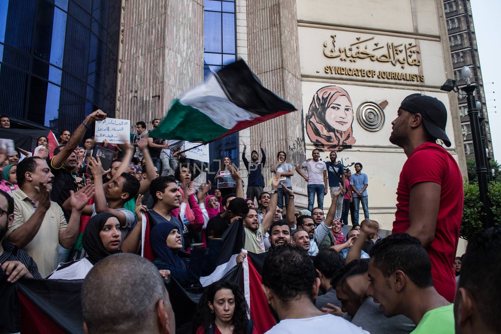 EGYPT, Cairo: Protesters gathered outside the Syndicate of Journalists building in Cairo, Egypt on October 18, 2015 in a show of support for Palestinians. The activists demonstrated against the recent attacks in Jerusalem, the West Bank and Gaza. They raised the flag of Palestine as some people stood on Israel's flag in anger.