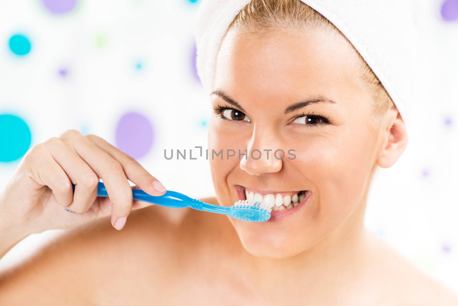 Portrait of Young cute woman brushing her teeth in the bathroom.
