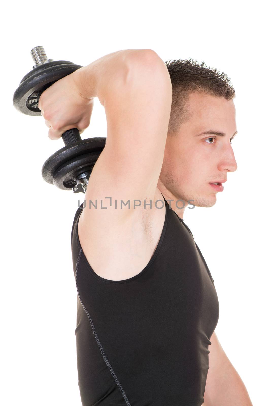 Sporty young man doing exercise to strengthen his triceps with dumbbells.