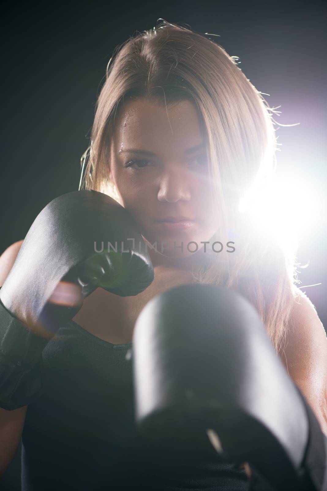 Portrait of Young beautiful boxing girl standing with a guard ready to punch. 