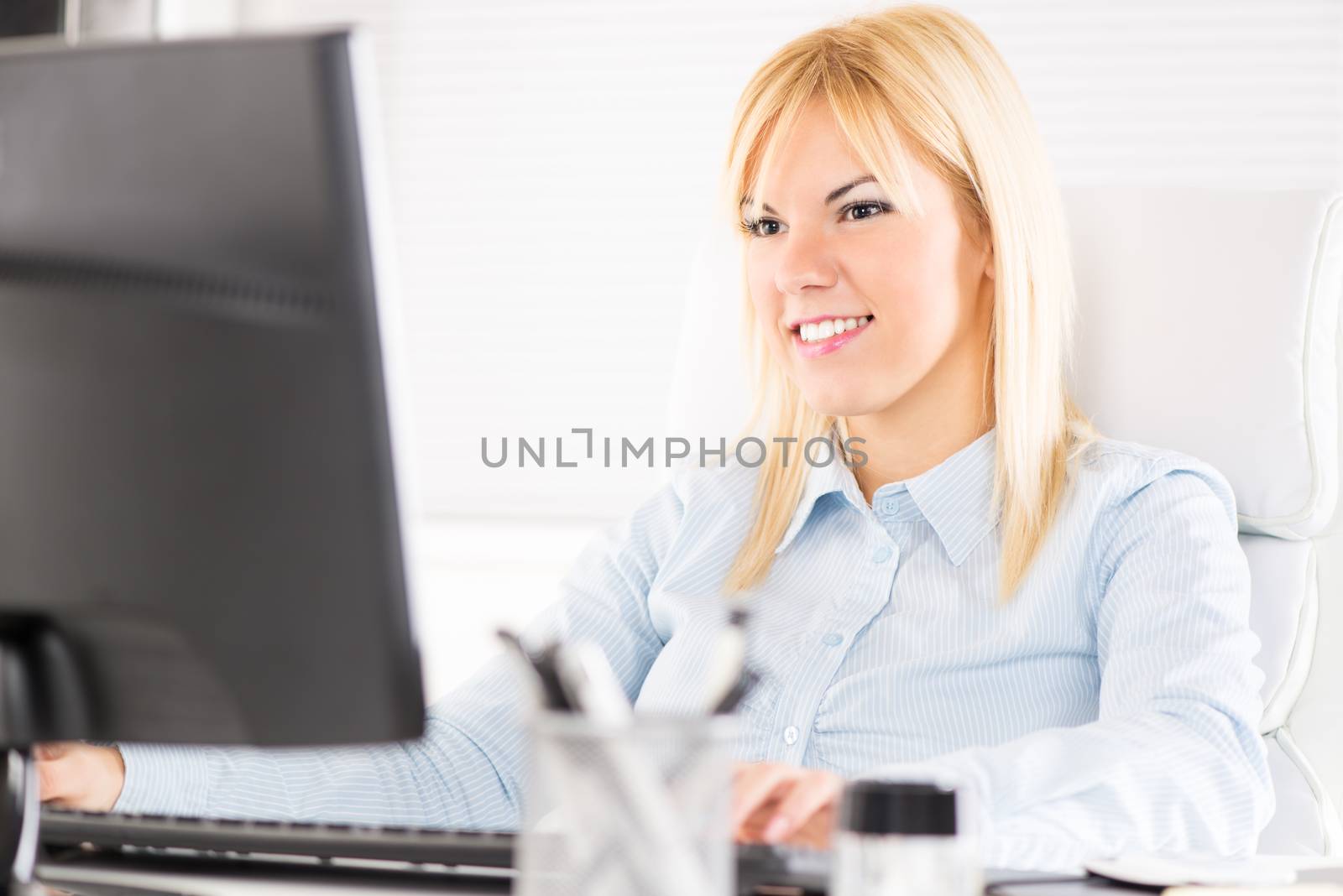 Beautiful Businesswoman working on the computer in the office.