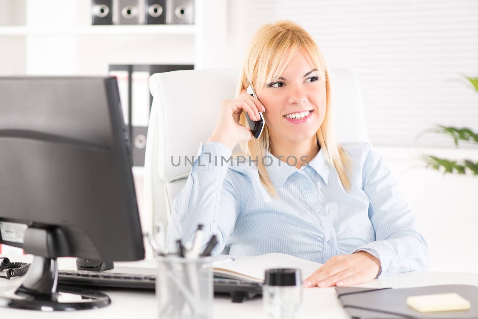 Beautiful Businesswoman telephoning in the office.