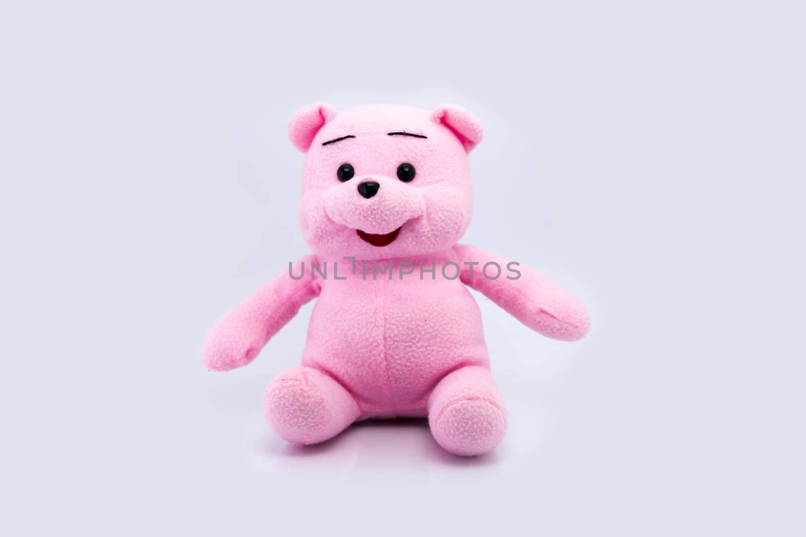 Pink teddy bear isolated on white background by teerawit