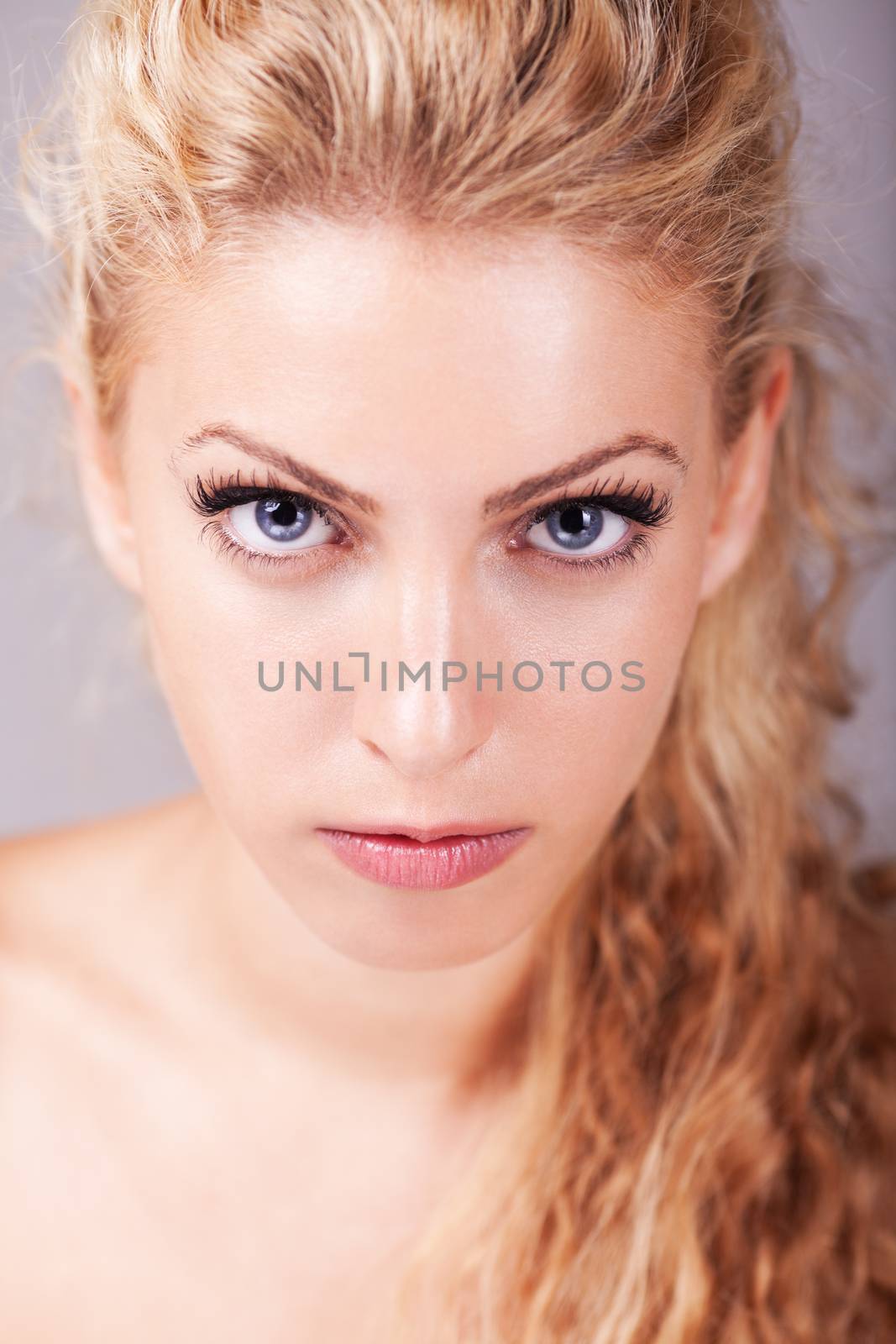 Portrait of beautiful blonde hair girl with grey eyes.