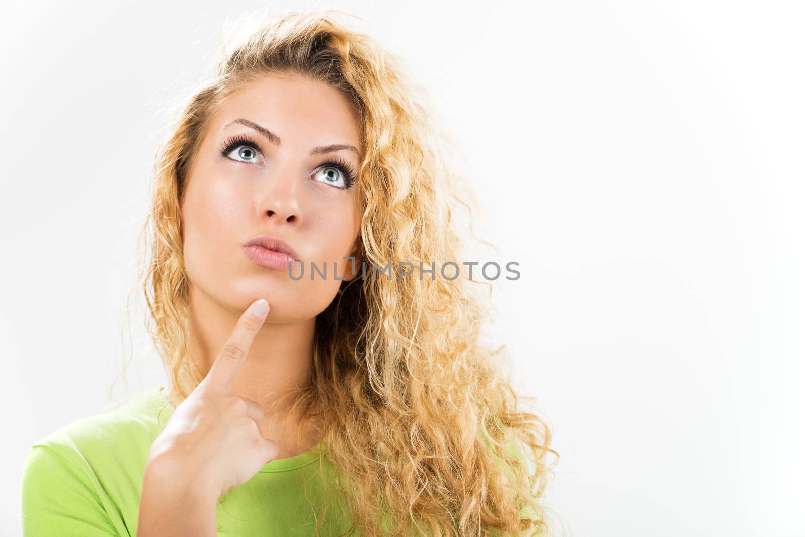 Portrait of beautiful young woman thinking and looking up. Close-up with white background.